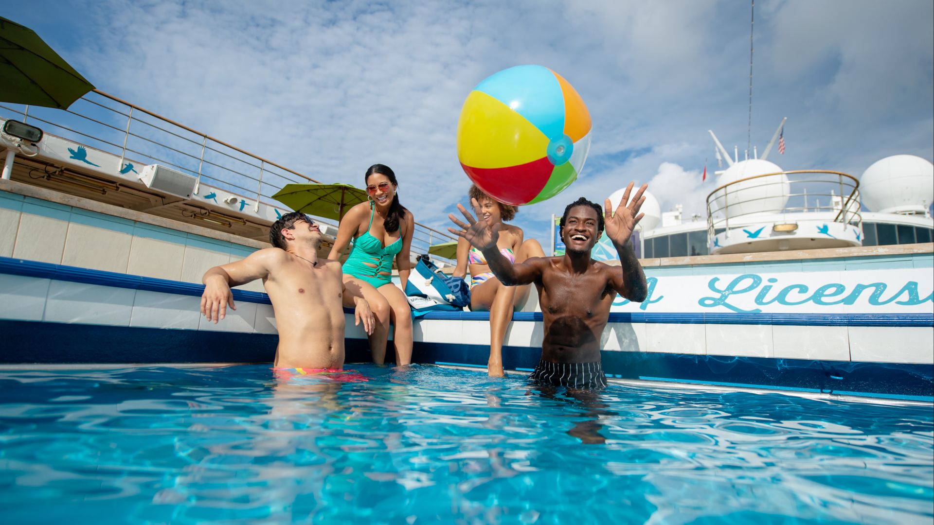 A Group Of People In A Pool With A Balloon