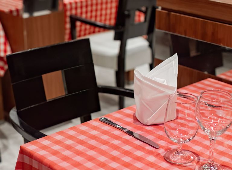 A Table With Glasses And Napkins
