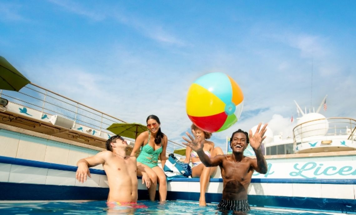 A Group Of People Playing With A Ball In A Pool